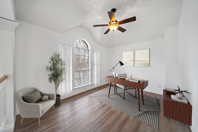 home office with vaulted ceiling, wood finished floors, a ceiling fan, and baseboards