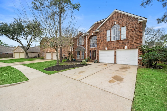 traditional-style home featuring a front yard, concrete driveway, and brick siding