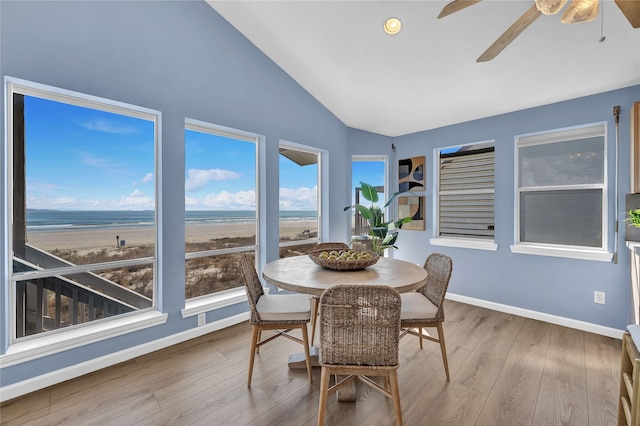 sunroom / solarium featuring vaulted ceiling, a healthy amount of sunlight, and ceiling fan