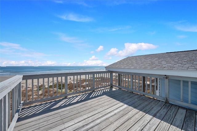 deck with a water view and a view of the beach