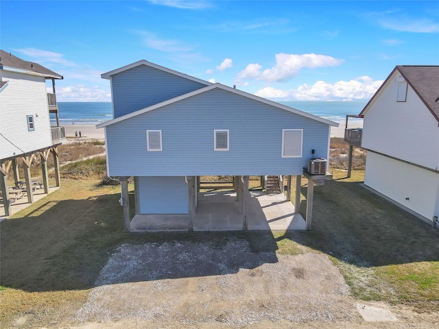 rear view of property featuring cooling unit and a water view