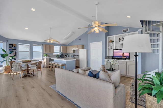 living room featuring ceiling fan, high vaulted ceiling, and light hardwood / wood-style floors