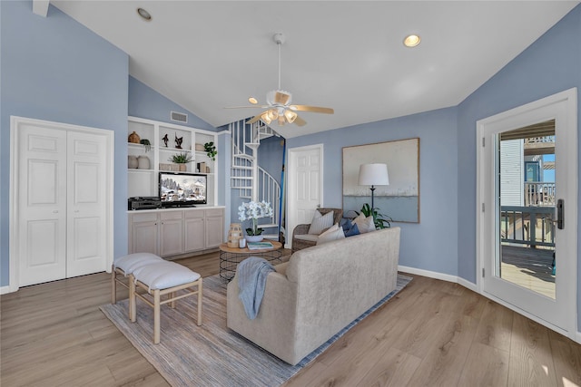 living room with ceiling fan, lofted ceiling, light hardwood / wood-style floors, and built in features