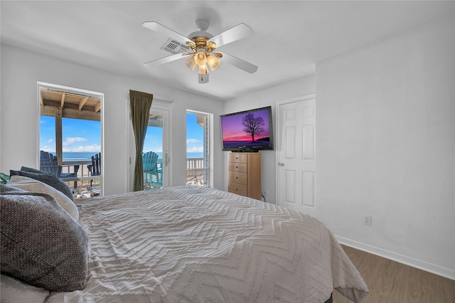 bedroom featuring ceiling fan, wood-type flooring, and access to exterior