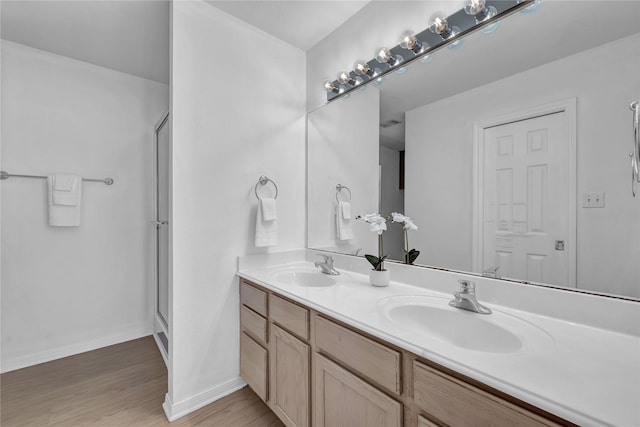 bathroom featuring vanity, a shower with door, and hardwood / wood-style floors