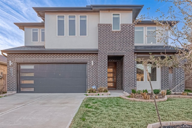 view of front of property with a garage and a front lawn