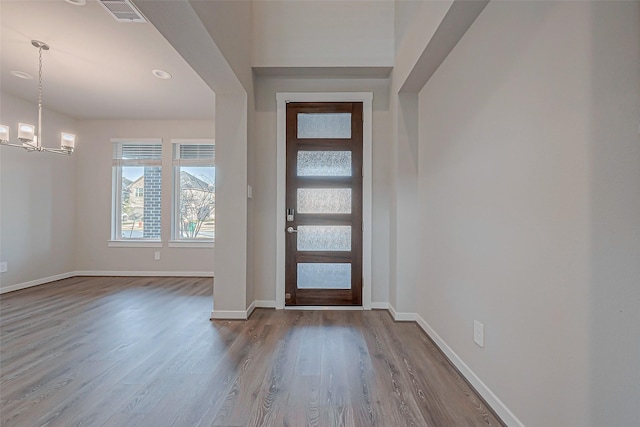 entryway featuring an inviting chandelier and light hardwood / wood-style floors