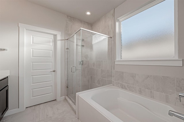 bathroom featuring vanity and shower with separate bathtub