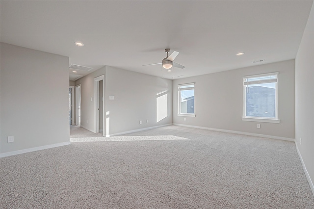 carpeted spare room featuring ceiling fan