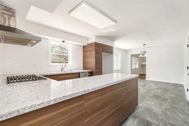 kitchen featuring island range hood, sink, light stone counters, stainless steel appliances, and a textured ceiling