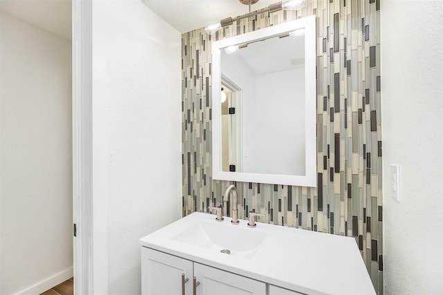 bathroom with tasteful backsplash and vanity