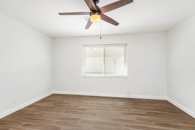 empty room featuring hardwood / wood-style floors and ceiling fan