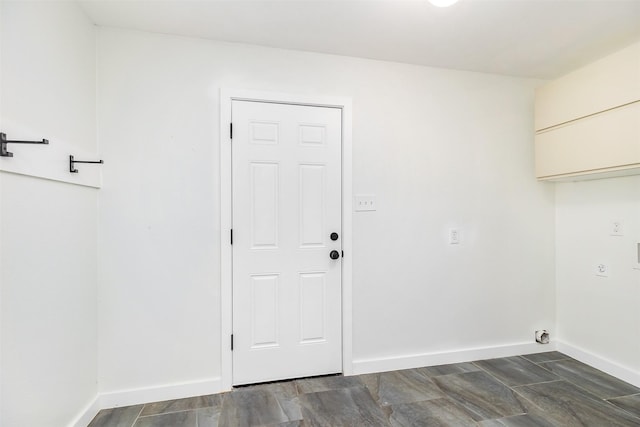 washroom featuring dark hardwood / wood-style flooring and electric dryer hookup