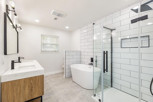 bathroom featuring vanity and independent shower and bath