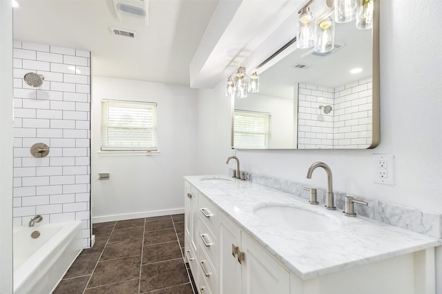 bathroom with tile patterned flooring, vanity, and tiled shower / bath combo