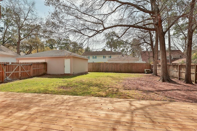 wooden terrace with a storage shed and a yard