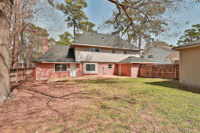 back of property featuring a lawn and a patio