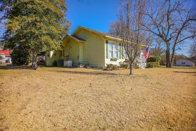 view of property exterior featuring cooling unit and a lawn