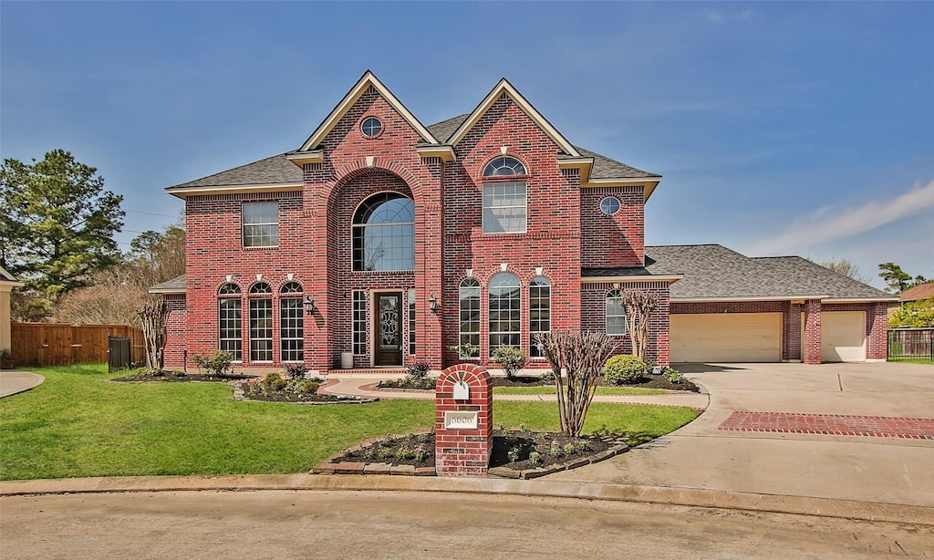 view of front facade with a garage, central AC unit, and a front lawn