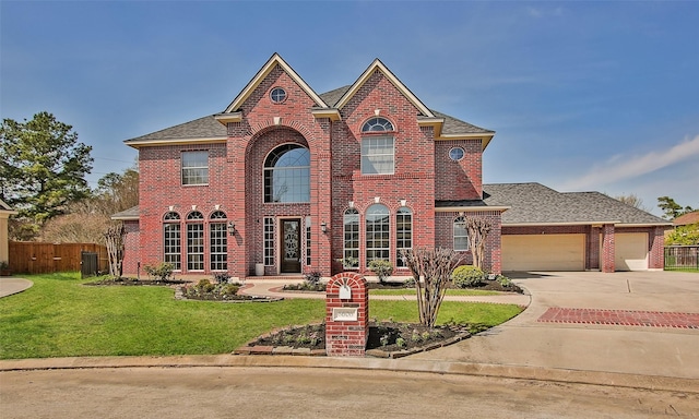 view of front facade with a garage, central AC unit, and a front lawn