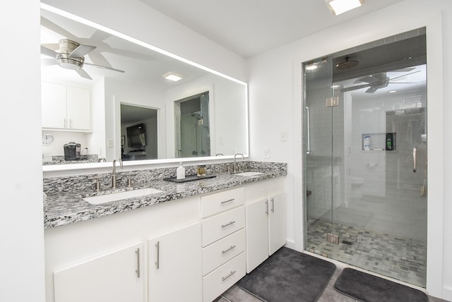 bathroom with vanity, tile patterned floors, a shower with door, and ceiling fan