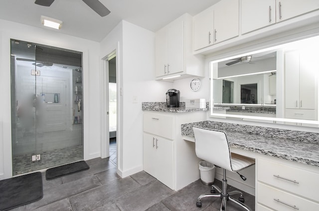 bathroom featuring vanity, an enclosed shower, and ceiling fan