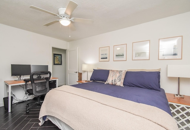 bedroom featuring a textured ceiling, dark hardwood / wood-style floors, and ceiling fan