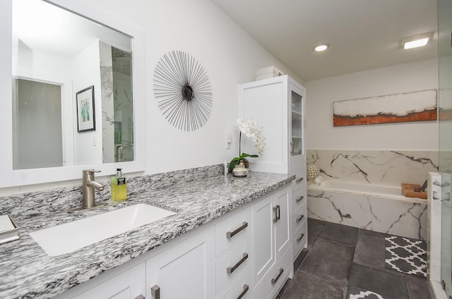 bathroom featuring vanity, plus walk in shower, and tile patterned flooring