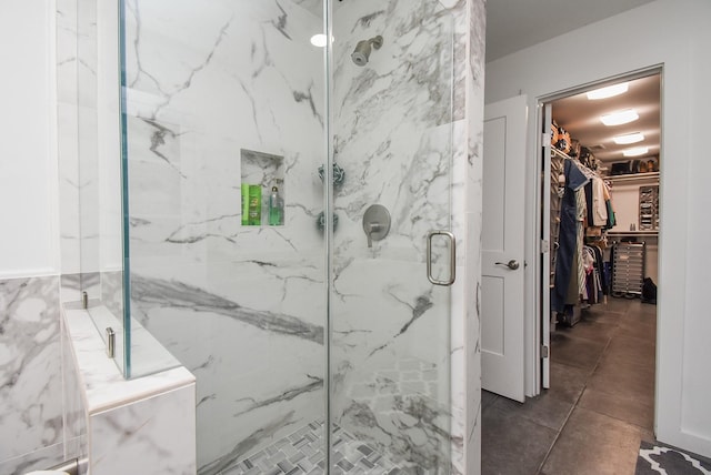 bathroom featuring tile patterned floors and a shower with shower door