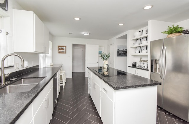 kitchen with sink, white cabinetry, a center island, stainless steel refrigerator with ice dispenser, and black electric cooktop