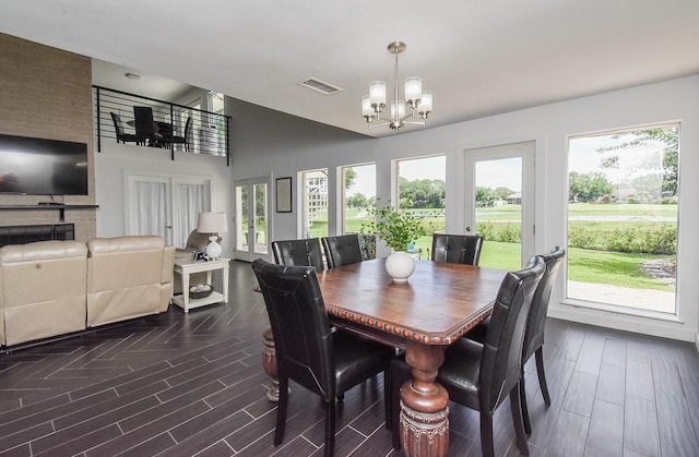 dining space featuring a notable chandelier and vaulted ceiling