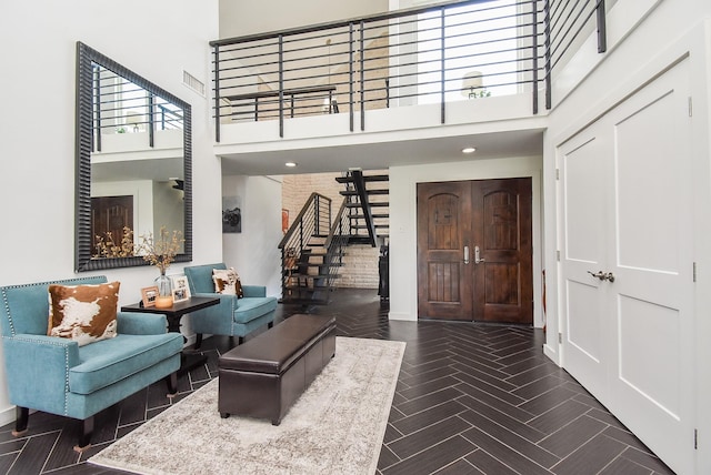 foyer entrance with a towering ceiling