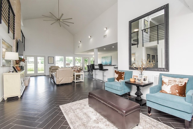 living room featuring dark parquet flooring, ceiling fan, high vaulted ceiling, and french doors