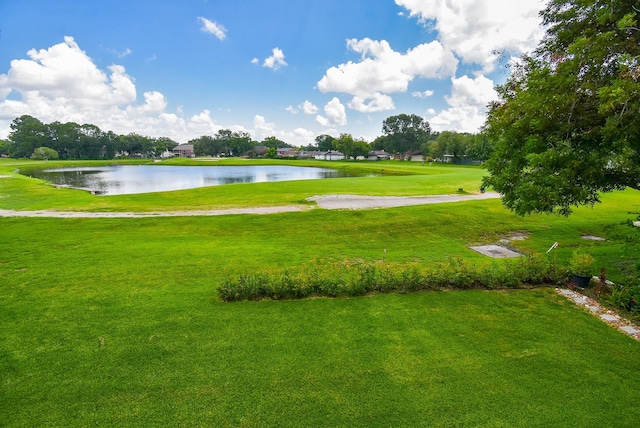 surrounding community featuring a yard and a water view