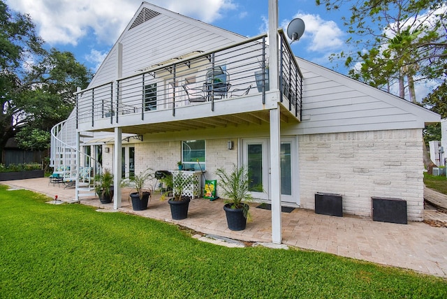 back of house with french doors, a yard, and a patio area