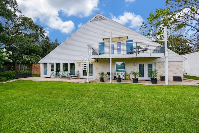 back of property featuring a yard, a patio area, and french doors