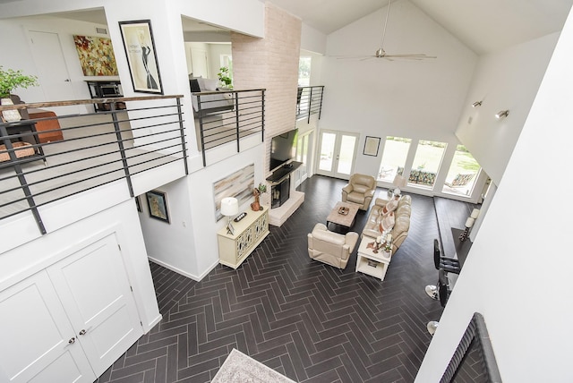 living room with ceiling fan and high vaulted ceiling