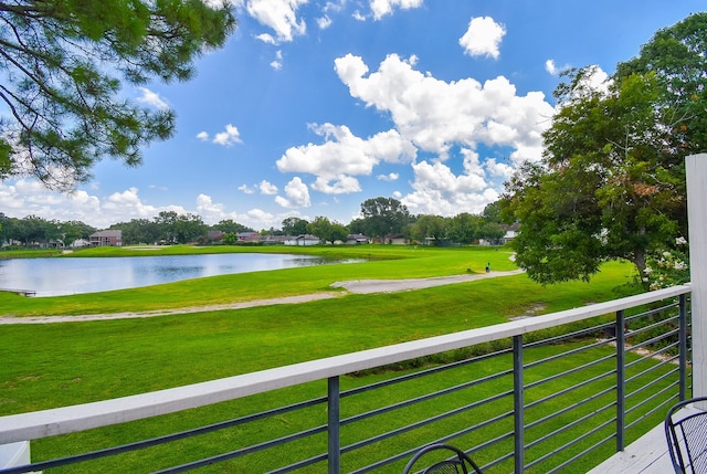 view of community with a water view and a lawn