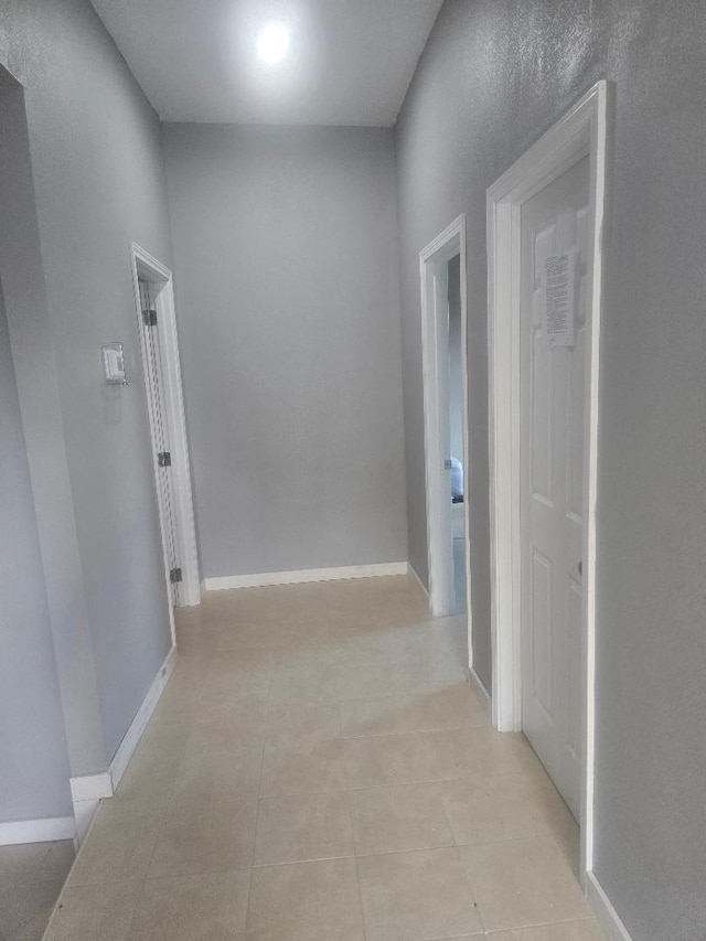 corridor with light tile patterned floors