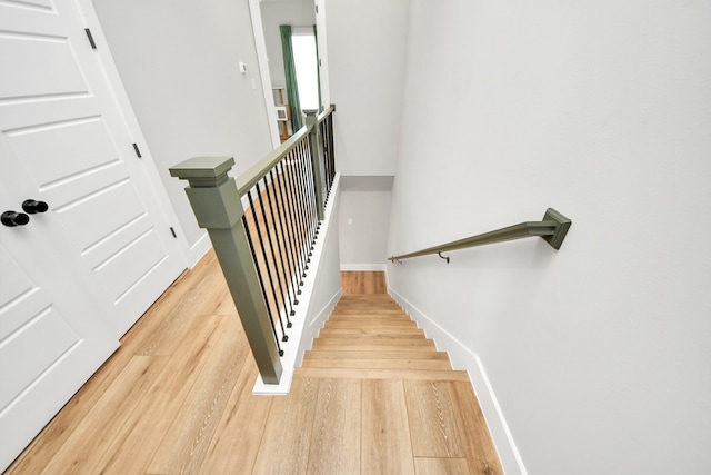 stairs featuring wood-type flooring