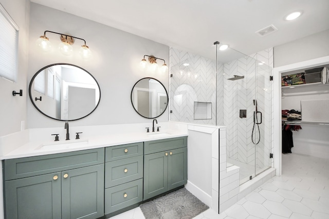 bathroom featuring tile patterned floors, vanity, and a shower with shower door