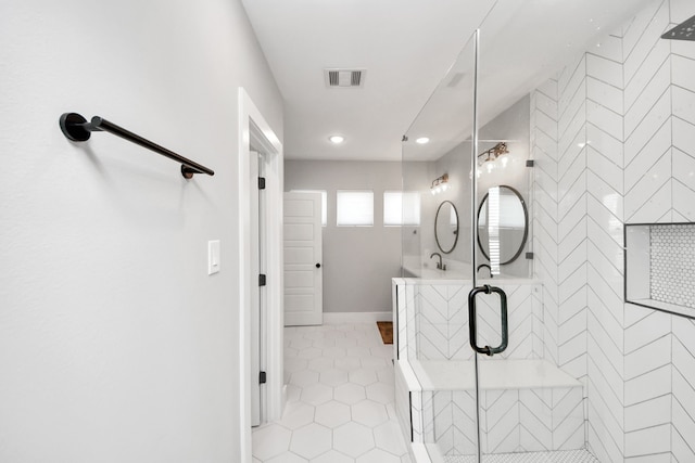 bathroom with an enclosed shower and tile patterned floors