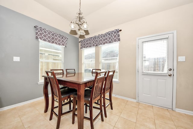 tiled dining area featuring a chandelier