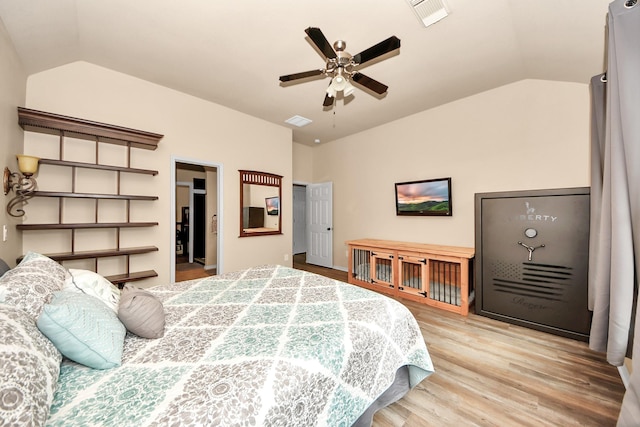 bedroom featuring lofted ceiling, light hardwood / wood-style flooring, and ceiling fan