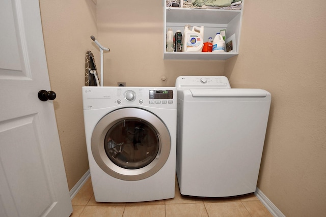 washroom featuring washer and dryer and light tile patterned floors