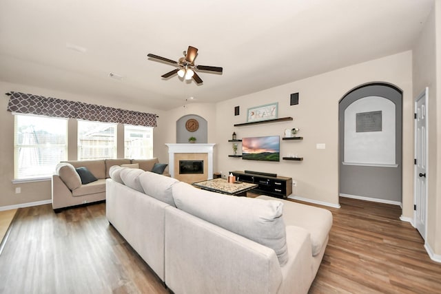 living room with ceiling fan and wood-type flooring