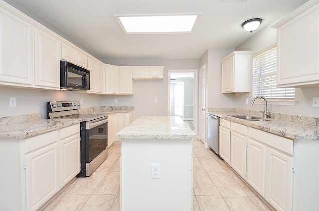 kitchen with stainless steel appliances, a center island, light tile patterned flooring, and a sink