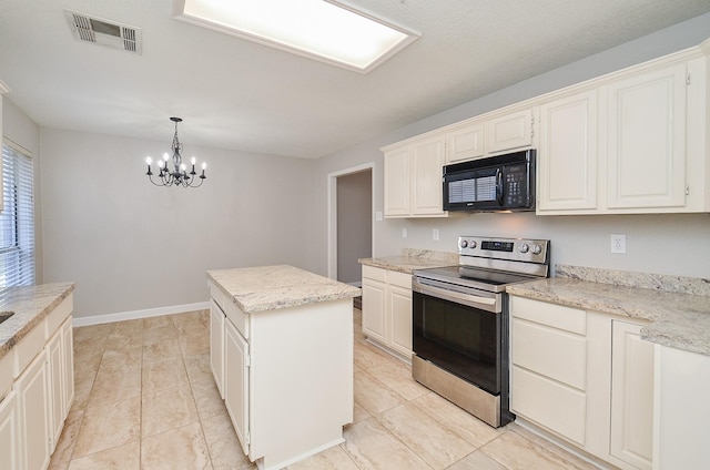 kitchen featuring black microwave, visible vents, a center island, stainless steel electric range oven, and decorative light fixtures