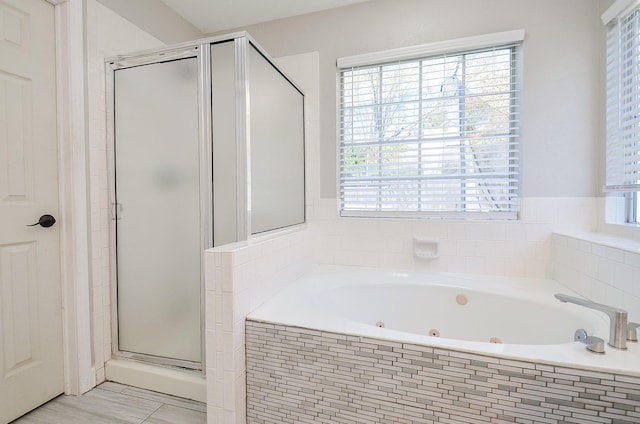 bathroom with a whirlpool tub and a shower stall