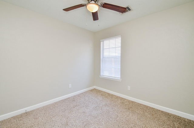 carpeted empty room featuring visible vents, ceiling fan, and baseboards